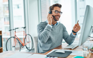 Shot of a young call centre agent working in an office