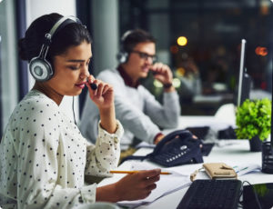 Two contact center agents speaking on the phone.