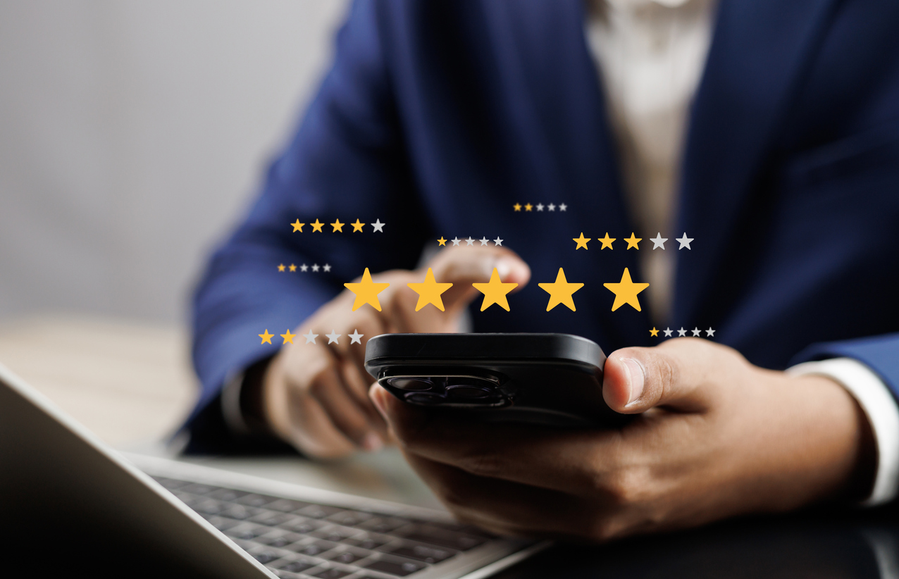 Person holding phone with graphics of google reviews star rating