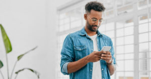 A man on his phone as part of the end-to-end customer experience