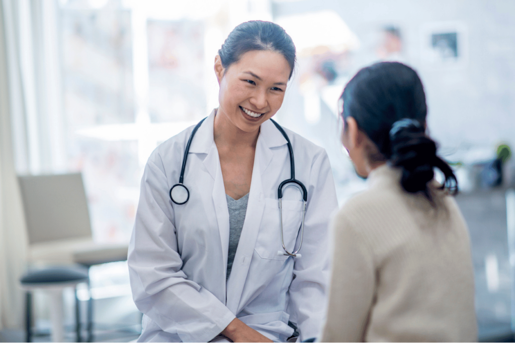 St. Luke's Medical Centers + InMoment: image of female doctor greeting woman in a clinical setting